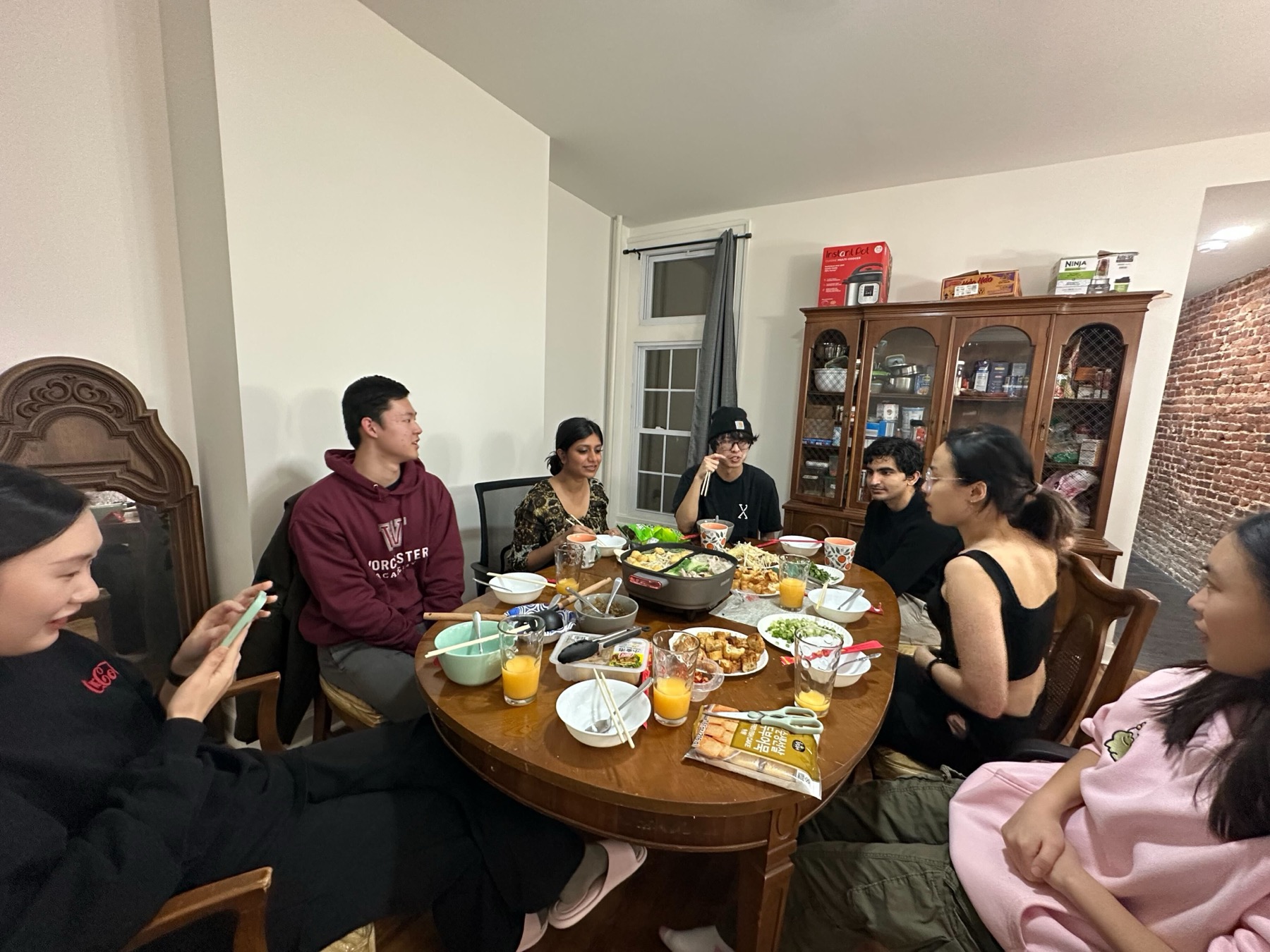 Lab members sitting around a table for hot pot.